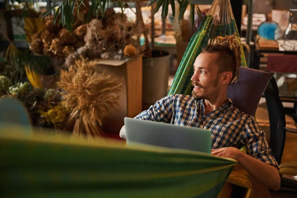 handsome-young-man-using-modern-laptop-at-home-